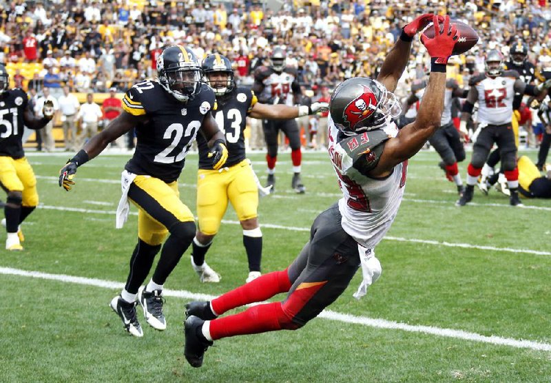 Tampa Bay Buccaneers wide receiver Vincent Jackson (83) makes a catch in front of Pittsburgh Steelers cornerback William Gay (22) for a touchdown with seven seconds left in the fourth quarter of an NFL football game on Sunday, Sept. 28, 2014 in Pittsburgh. The score lifted the Buccaneers to a 27-24 win. (AP Photo/Gene Puskar)