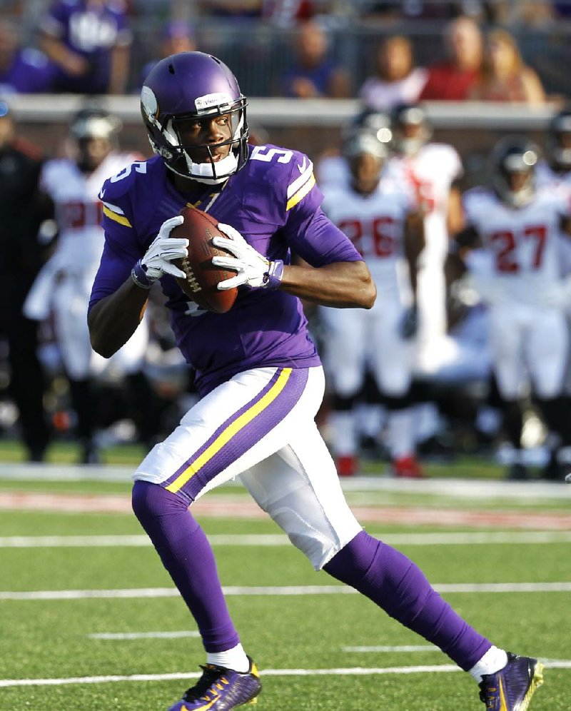 Minnesota Vikings quarterback Teddy Bridgewater (5) looks to pass during the first half of an NFL football game against the Atlanta Falcons, Sunday, Sept. 28, 2014, in Minneapolis. (AP Photo/Ann Heisenfelt)