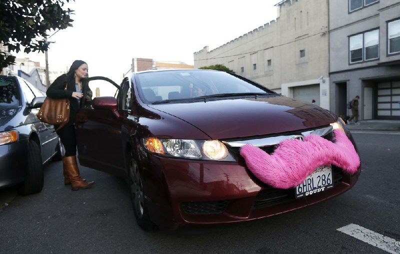 FILE - In this Jan. 4, 2013 file photo, Lyft passenger Christina Shatzen gets into a car driven by Nancy Tcheou, in San Francisco. Boston is considering restrictions on ride-sharing services like Uber, Lyft and Sidecar and lodging websites like Airbnb, HomeAway and FlipKey, which allow users to book short-term stays in private residences. (AP Photo/Jeff Chiu, File)