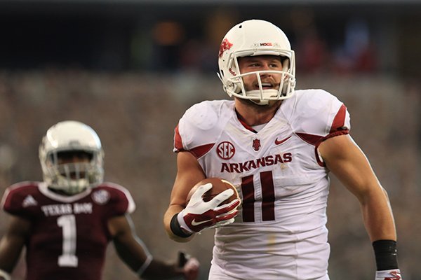 Arkansas tight end AJ Derby outruns a Texas A&M defender for a touchdown in the third quarter of a game Saturday, Sept. 27, 2014 at AT&T Stadium in Arlington, Texas. 