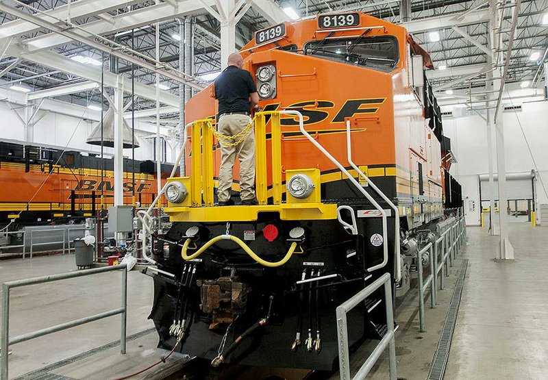 Todd Kindel, manager of advanced methods for GE Transportation, stands on a finished diesel locomotive, for BNSF Railway Co., at the General Electric (GE) Manufacturing Solutions facility in Fort Worth, Texas, U.S., on Tuesday, Sept. 2, 2014. GE may put the lighting unit up for sale as Chief Executive Officer Jeffrey Immelt reshapes the company around its high-margin industrial units, said Nicholas Heymann, a William Blair & Co. analyst in New York. After agreeing to sell its home-appliance division, the light-bulb arm is the only remaining consumer-products business within GE, which has shifted its focus to aviation and oil and gas. Photographer: Rex C. Curry/Bloomberg *** Local Caption *** Todd Kindel