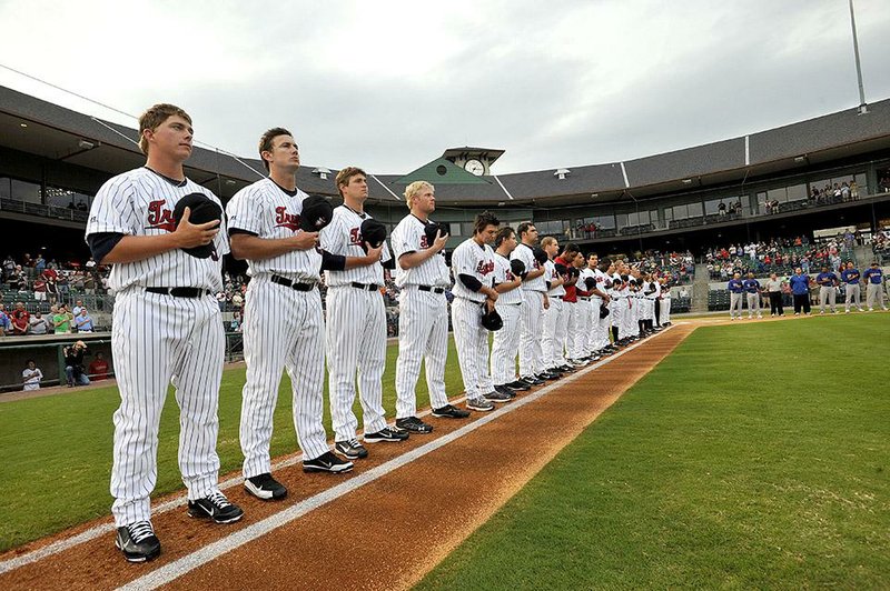 Arkansas Democrat-Gazette/KAREN E. SEGRAVE
4/14/11

Members of the Arkansas Travelers place their hats over their hearts during the singing of the "National Anthem" Thursday evening at their home opener against the Midland Rockhounds.