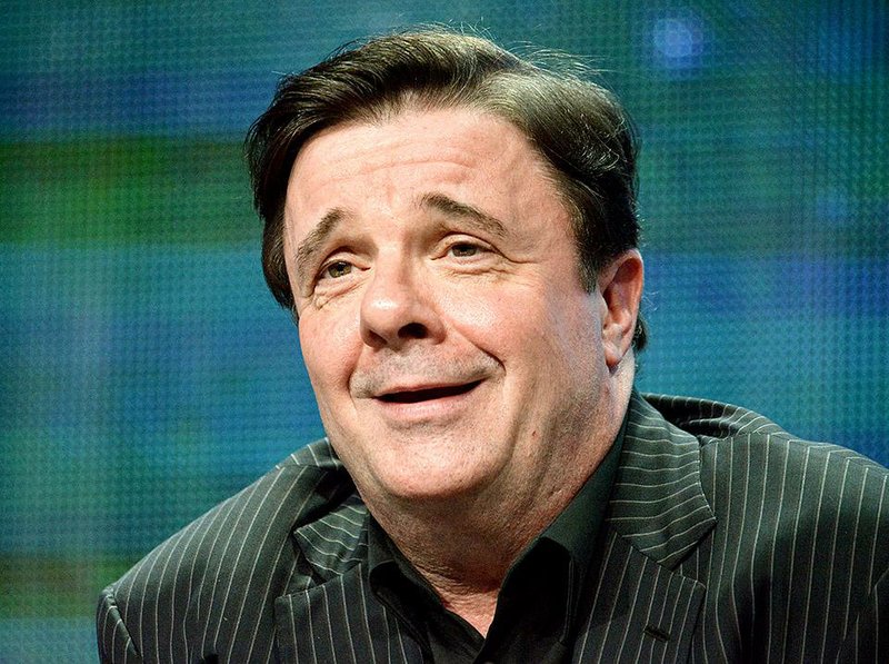 FILE - In this July 22, 2014 file photo, actor Nathan Lane speaks on stage during the “Live from Lincoln Center”  "The Nance" panel at the the PBS 2014 Summer TCA in Beverly Hills, Calif.  Simon & Schuster Books for Young Readers announced Monday, Sept. 29, that the Broadway actor known for his starring role in "The Producers" has a deal for a picture book, "Naughty Mabel." Scheduled for next fall, the book was co-written by Lane and his partner, Devlin Elliott, and will be illustrated by Dan Krall. (Photo by Richard Shotwell/Invision/AP, File)