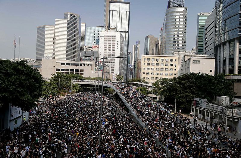 Pro-democracy protesters flood the streets around the government headquarters, Monday, Sept. 29, 2014 in Hong Kong. Pro-democracy protesters expanded their rallies throughout Hong Kong on Monday, defying calls to disperse in a major pushback against Beijing's decision to limit democratic reforms in the Asian financial hub. (AP Photo/Wong Maye-E)