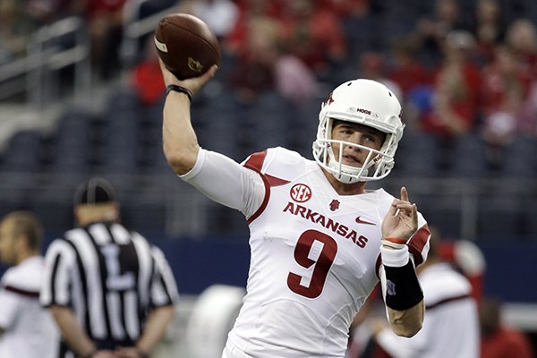 Arkansas quarterback Rafe Peavey passes during warm ups before an NCAA college football game against Texas A&M, Saturday, Sept. 27, 2014, in Arlington, Texas. (AP Photo/Tony Gutierrez)