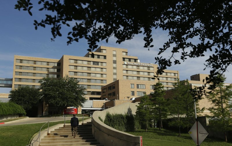 A man walks up the stairway leading to the Texas Health Presbyterian Hospital in Dallas, Tuesday, Sept. 30, 2014. A patient in the hospital is showing signs of the Ebola virus and is being kept in strict isolation with test results pending, hospital officials said Monday. 