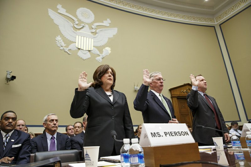 Secret Service Director Julia Pierson, left, is sworn in on Capitol Hill in Washington on Tuesday, Sept, 30, 2014, prior to testifying before the House Oversight Committee as it examines details surrounding a security breach at the White House when a man climbed over a fence, sprinted across the north lawn and dash deep into the executive mansion before finally being subdued. Pierson is joined at the witness table by Ralph Basham, a former Secret Service director, now a partner with Command Consulting Group, a private security firm, and Todd M. Keil, far right, senior adviser with TorchStone Page, a private security firm. 
