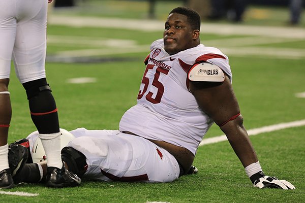 Arkansas offensive lineman Denver Kirkland sits on the field following a game against Texas A&M on Saturday, Sept. 27, 2014 at AT&T Stadium in Arlington, Texas. 