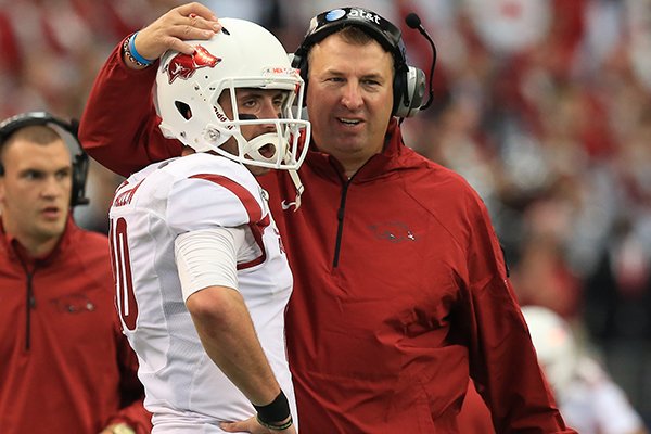 Arkansas coach Bret Bielema congratulates quarterback Brandon Allen following a second quarter touchdown against Texas A&M on Saturday, Sept. 27, 2014 at AT&T Stadium in Arlington, Texas. 