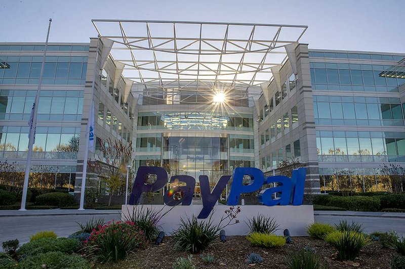 The sun reflects off windows at eBay’s PayPal Inc. headquarters in San Jose, Calif., in this file photo. EBay said Tuesday it will spin off PayPal into a separate, publicly traded company.