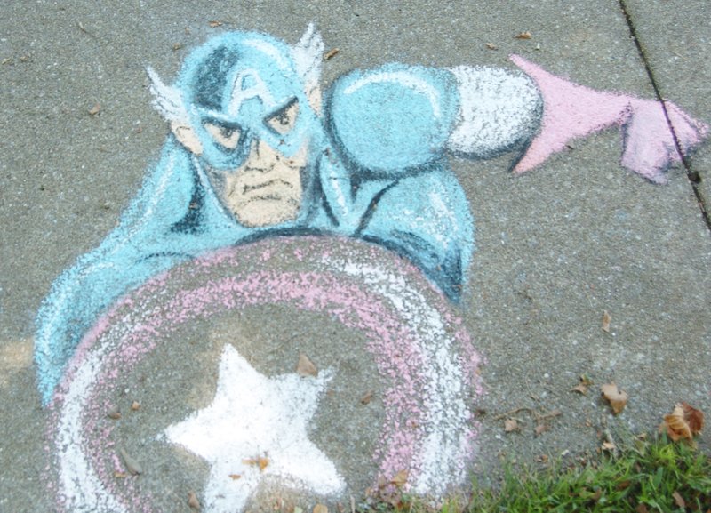 Photo by Mike Eckels A mysterious sidewalk-art piece of comic book superhero Captain America appeared on the sidewalk leading to the boat dock at Crystal Lake Park Sept. 19. Although the artist is unknown on this piece, the work shows real talent for an art form that dates back to the 1500s. The exhibit will be on display until the next heavy rain washes it away.