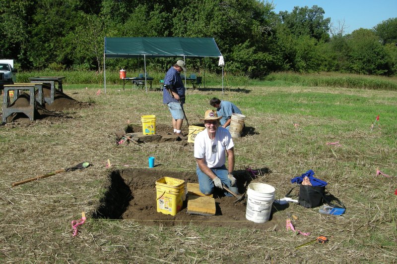 COURTESY PHOTO Arkansas Archeological Society volunteer Jim Cherry works in 2011 to excavate the site of the William Rogers house at Prairie Grove Battlefield State Park. Jared Pebworth and Aden Jenkins, background, uncover foundation stones of the southwest corner of the house.