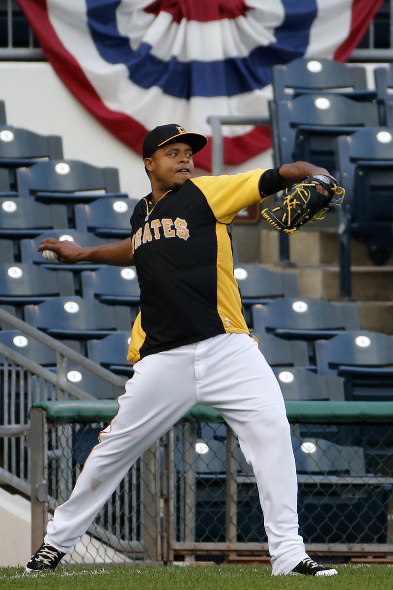 Pittsburgh Pirates starting pitcher Edinson Volquez throws long toss in the outfield during a team workout at PNC Park in Pittsburgh Tuesday, Sept. 30, 2014. Volquez gets the start against the San Francisco Giants in Wednesday's National League baseball Wild Card game in Pittsburgh. 