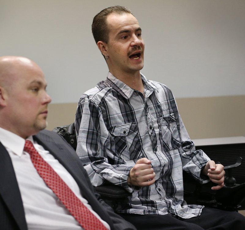 In this April 25, 2013, file photo, attorney Michael Evans, left, listens in his office in Denver, as his client Brandon Coats talks about the Colorado Court of Appeals ruling that upheld Coats being fired from his job after testing positive for the use of medical marijuana. The Colorado Supreme Court is set to hear arguments in the marijuana-related firing case that could have big implications for the states pot smokers. Coats is a quadriplegic medical marijuana patient who was fired from his job at Dish Network after failing a drug test in 2010. Coats says he needs the drug to help with violent spasms he has suffered since he was paralyzed in a car accident as a teenager.