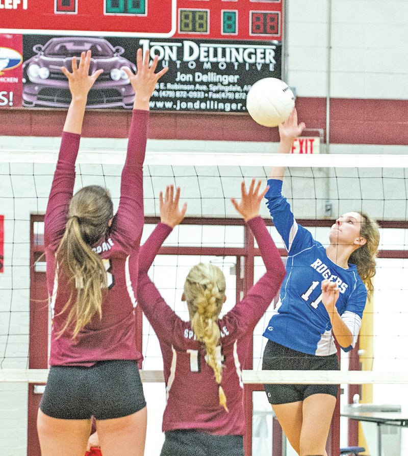 STAFF PHOTO ANTHONY REYES &#8226; @NWATONYR Emily Sherrill, Rogers High senior, spikes against Springdale on Tuesday at Bulldog Gymnasium in Springdale. Rogers won in straight sets.