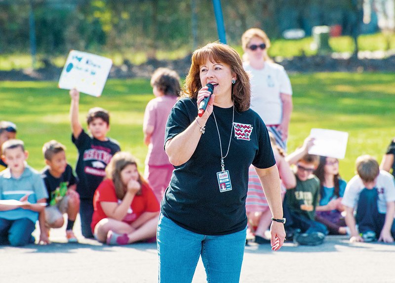 Michelle Atherton, principal of Westside Elementary School in Cabot, talks to students gathered in the parking lot during the Inspiration Run event about getting them and their families up and moving.
