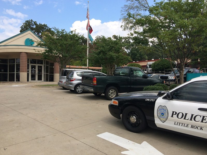 Little Rock police respond to a bank robbery Wednesday at the First Security Bank at 4936 W. Markham St. It's the second time the branch has been robbed in 2014.