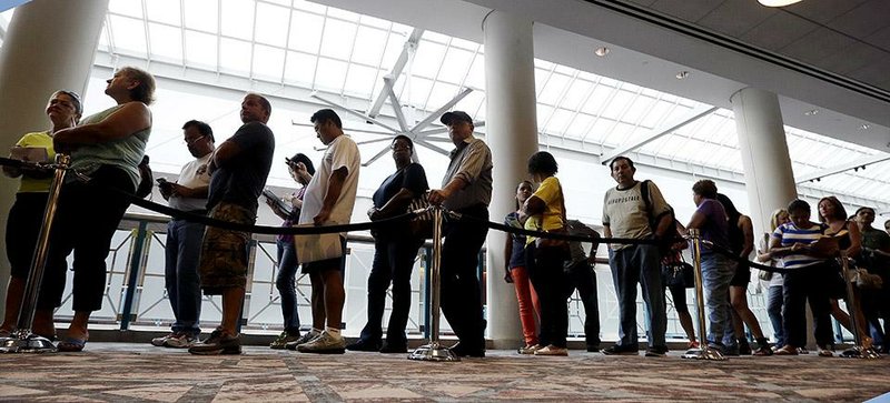 Unemployed New Jersey residents line up to apply for benefits in Atlantic City last month. Payroll processor ADP said Wednesday that U.S. hiring in September was up from August.