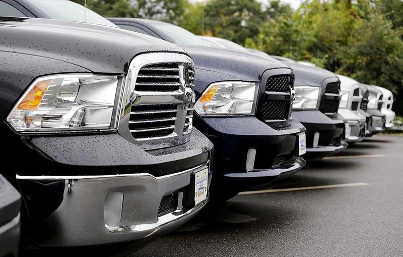 Ram pickups are lined up for sale Wednesday at Bill DeLuca’s dealership in Haverhill, Mass. Discounts on pickups strengthened U.S. auto sales in September.