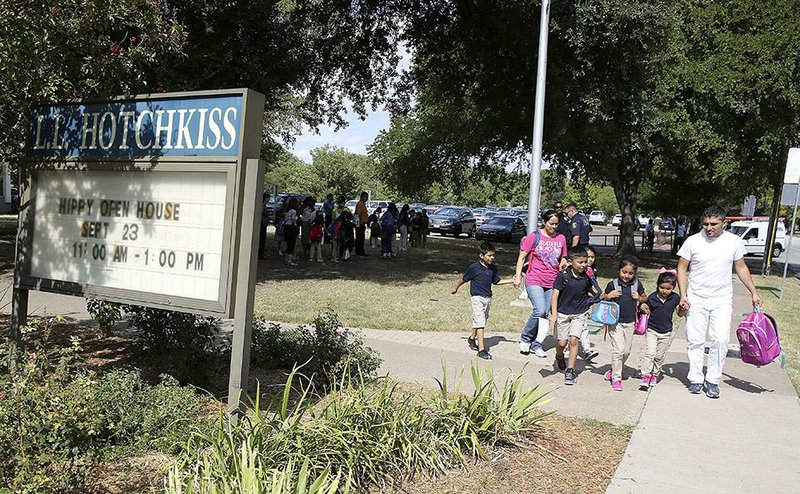 Parents pick up their children Wednesday at L.L. Hotchkiss Elementary in Dallas after school officials announced that Hotchkiss was one of four schools attended by students who possibly had contact with a man infected with the Ebola virus.