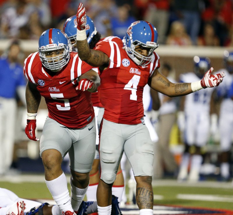 Mississippi defensive tackle Robert Nkemdiche (5) and linebacker Denzel Nkemdiche (4), his brother, celebrate Memphis quarterback Paxton Lynch fumbled during the second half of an NCAA college football game in Oxford, Miss., Saturday, Sept. 27, 2014. No. 10 Mississippi won 24-3.