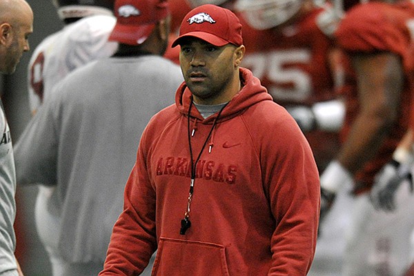 Arkansas Assistant Coach Joel Thomas works with the Razorbacks during practice on Saturday, March 30, 2013 in Fayetteville. 