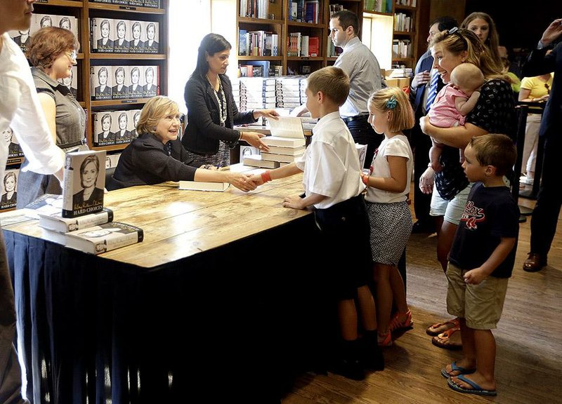 Hillary Rodham Clinton greets a young fan at an appearance at a bookstore Thursday in Coral Gables, Fla., for her book, Hard Choices. The former secretary of state also attended a fundraiser Thursday for Charlie Crist, a Democrat running for governor of Florida.