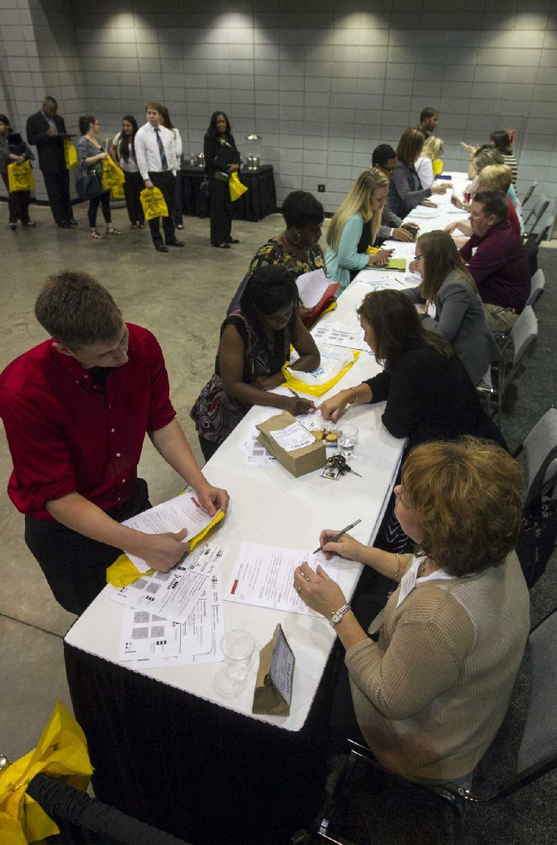 Job seekers wait to have their resumes reviewed Tuesday during the Arkansas Democrat-Gazette and Central Arkansas Human Resources Association Fall Job Fair at the Statehouse Convention Center in Little Rock. The number of job openings nationally rose to 4.84 million in August, the Labor Department said Tuesday.