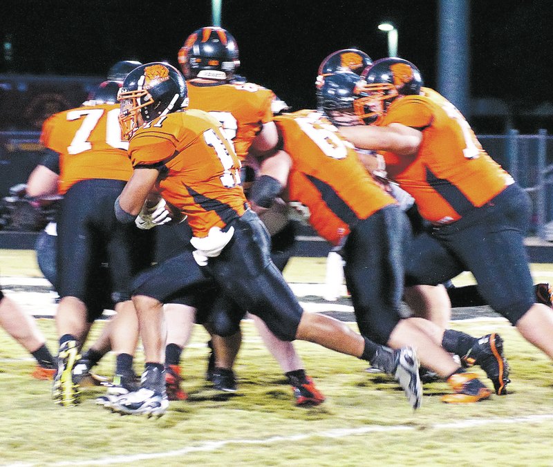 Photo by Randy Moll Gravette senior Cedric Duarte runs the ball behind the blocking of his offensive line during play against Prairie Grove in Gravette on Friday, Oct. 3, 2014.