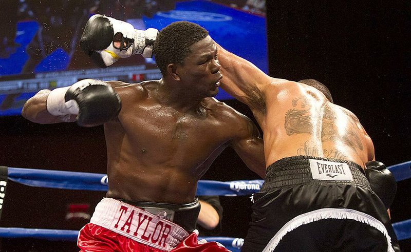 Jermain Taylor (left) throws a punch after dodging a blow from Sam Soliman during their IBF middleweight championship bout Oct. 8, 2014 in Biloxi, Miss. Taylor won the bout by a unanimous decision.