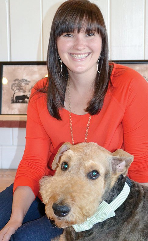 Artist Beth Whitlow of Russellville is shown with Case, one of her three dogs and the subject of one of 
Whitlow’s first portraits.