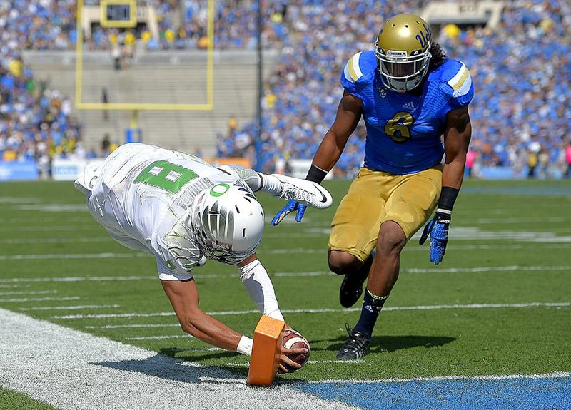 Oregon QB Marcus Mariota bringing in the green for Ducks