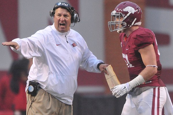 Arkansas coach Bret Bielema talks with linebacker Brooks Ellis during a game Saturday, Oct. 11, 2014 at Razorback Stadium in Fayetteville.