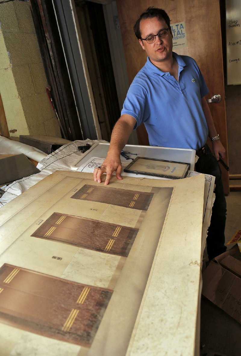 Arkansas Democrat-Gazette/JOHN SYKES JR. - Style story on cool old artifacts found during the recent rash or renovations of old downtown buildings. David Robinson, managing director of Reed Realty Advisors, points out a drawing of the elevators of the Boyle Building, dating from the 1940's.