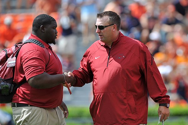 Arkansas head coach Bret Bielema, right, talks with graduate assistant coach Alfred Davis prior to a game Saturday, Aug. 30, 2014 at Jordan-Hare Stadium in Auburn, Alabama. 