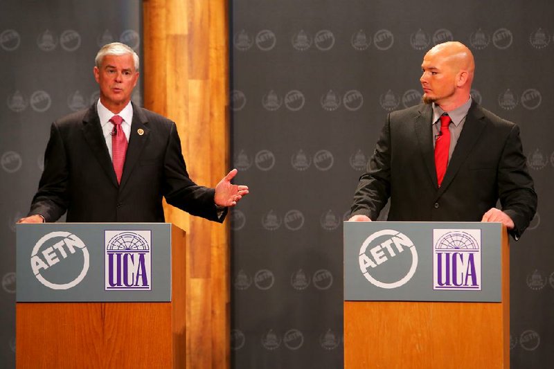 Republican U.S. Rep. Steve Womack (left) debates Libertarian candidate Grant Brand on Tuesday at the University of Central Arkansas in Conway.