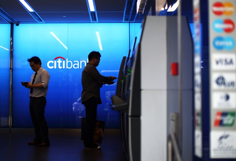 A customer uses an ATM at a Citigroup Inc. bank branch in Hong Kong last week. Citigroup was one of three big U.S. banks to re lease quarterly earnings reports Tuesday.