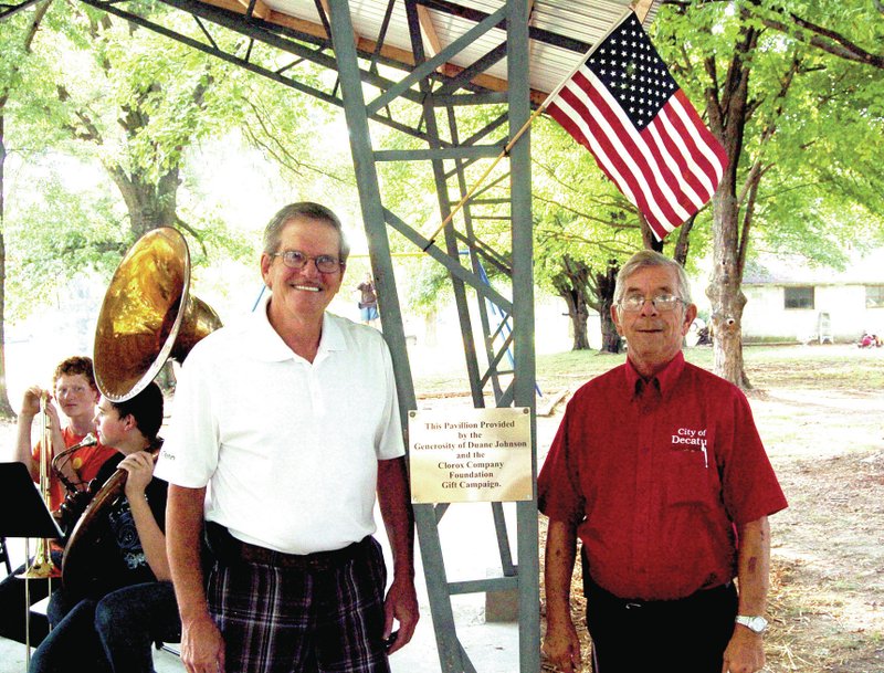 Photo by Mike Eckels Decatur Mayor Charles Linam (left) and Duane Johnson pose in front of the plaque dedicating the new pavilion at Johnson Park Sept. 29. Funding for the pavilion project was made possible by Johnson and the Clorox Company Foundation Gift Campaign.