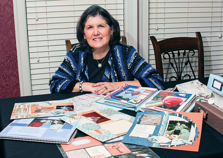 Jeanne Trawick, a retired Conway elementary-school assistant principal, sits with scrapbooks that she has made. Trawick and a team of fellow church members will teach a free scrapbooking class Saturday in Conway as part of the St. Joseph Catholic Church Beacon of Hope grief ministry.