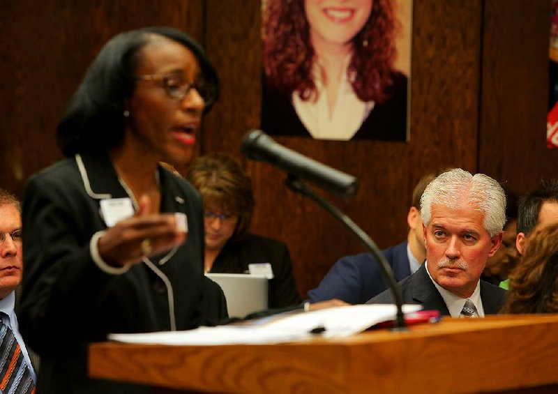 North Little Rock School District Superintendent Kelly Rodgers listens Wednesday as Phillis Anderson, with Lighthouse Academies, speaks before the state Charter Authorizing Panel about why she thinks North Little Rock needs her charter school.