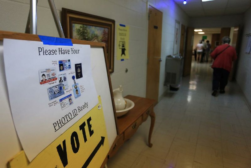 FILE — A sign at Woodlawn Baptist Church in Little Rock on May 24 reminded voters that a photo ID is required to cast ballots. The Arkansas Supreme Court on Wednesday ruled unanimously that the voter-ID law violates the state's Constitution.