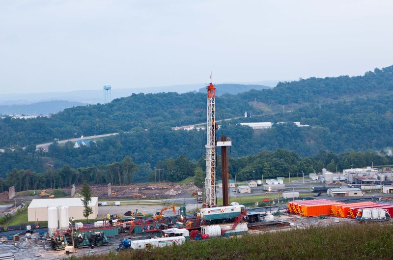 In this Aug. 6, 2011 file photo, a natural gas well operated by Northeast Natural Energy is seen in Morgantown, W.Va. Cheap and plentiful natural gas isn't quite a bridge to a brighter energy future as claimed and wont slow global warming, a new study projects. Abundant natural gas in the United States has been displacing coal, which produces more of the chief global warming gas carbon dioxide. But the new international study says an expansion of natural gas use by 2050 would also keep other energy-producing technologies like wind, solar and nuclear, from being used more. And those technologies are even better than natural gas for avoiding global warming.