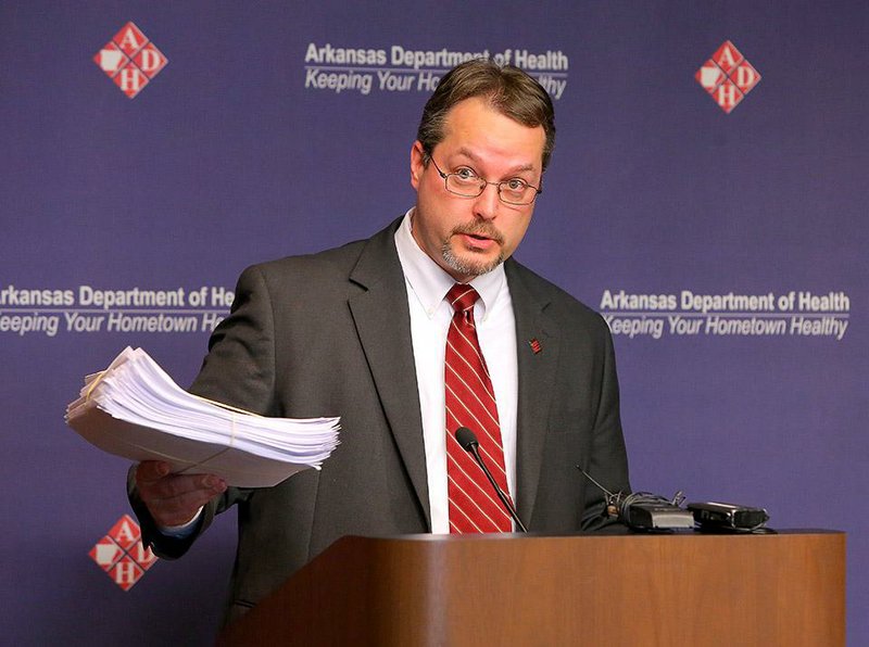 1/13/14
Arkansas Democrat-Gazette/STEPHEN B. THORNTON
Dirk Haselow, the state's epidemiologist and the medical director for communicable diseases, display a stack of flu cases that his agency hasn't yet counted in the flu numbers during a press conference Monday at the Arkansas Department of Health. 
