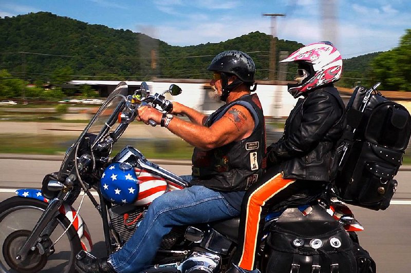 Ronnie “Stray Dog” Hall and his Mexican-born wife, Alicia, take a ride in Debra Granik’s documentary Stray Dog.