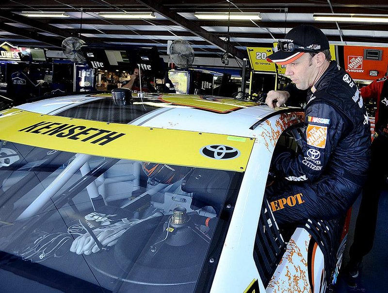 Matt Kenseth climbs into his car for practice for Sunday's NASCAR Geico 500 Sprint Cup Series auto race at Talladega Superspeedway Friday, Oct. 17, 2014, in Talladega, Ala.   (AP Photo/Rainier Ehrhardt)