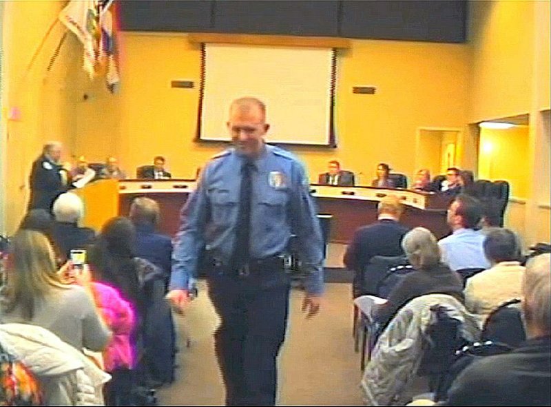 FILE - In this  Feb. 11, 2014 file image from video provided by the City of Ferguson, Mo., officer Darren Wilson attends a city council meeting in Ferguson.  Police identified Wilson, 28, as the police officer who shot Michael Brown on Aug. 9, 2014 in the St. Louis suburb. The incident sparked racial unrest and numerous protests, including some that turned violent. (AP Photo/City of Ferguson, File)
