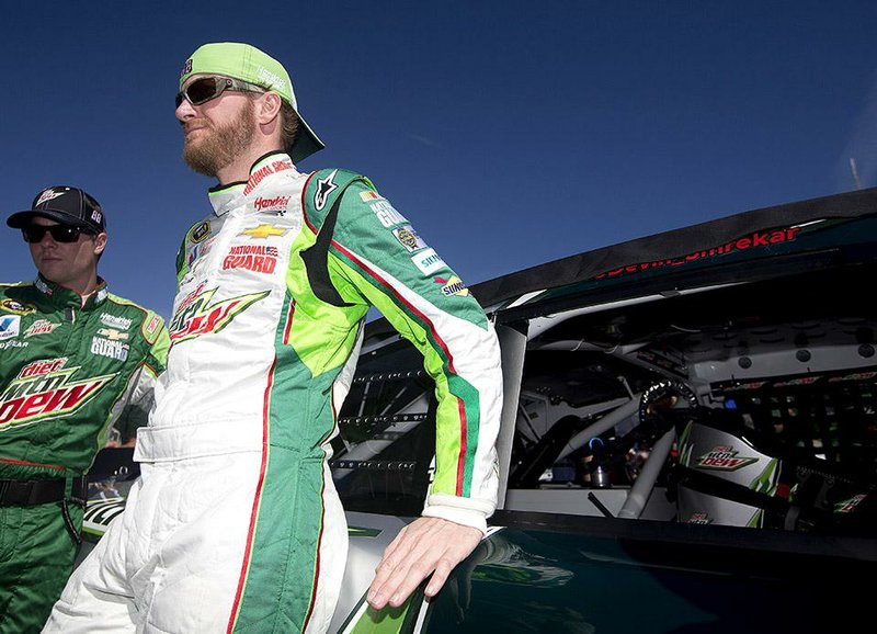 Dale Earnhardt Jr. stands by his car as he waits to start the NASCAR Sprint Cup Series auto race at Talladega Superspeedway, Sunday, Oct. 19, 2014, in Talladega, Ala. (AP Photo/John Bazemore)