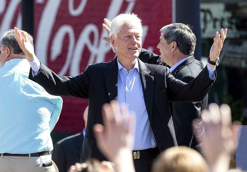 Arkansas Democrat-Gazette/MELISSA SUE GERRITS - 10/19/2014 - Former President Bill Clinton greets the crowd of volunteers and passersby in the Argenta neighborhood October 19, 2014. Clinton made a stop in Argenta as part of tour rallying with candidates Senator Mark Pryor D-ARK., Democratic gubernatorial candidate Mike Ross, and Congressional candidate Patrick Hays. The former president will be heading to Pine Bluff and Forrest City next. 