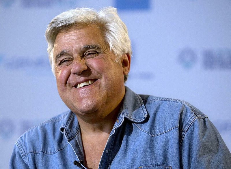 FILE - This May 21, 2014 file photo shows American comedian Jay Leno smiles during an interview with the Associated Press in Jerusalem.  CNBC is returning Leno to nightly television. The new show, tentatively titled "Jay Leno's Garage" and based on his Emmy Award-winning web series, will premiere in 2015, the network announced Wednesday, Oct. 15, 2014. (AP Photo/Sebastian Scheiner, File)