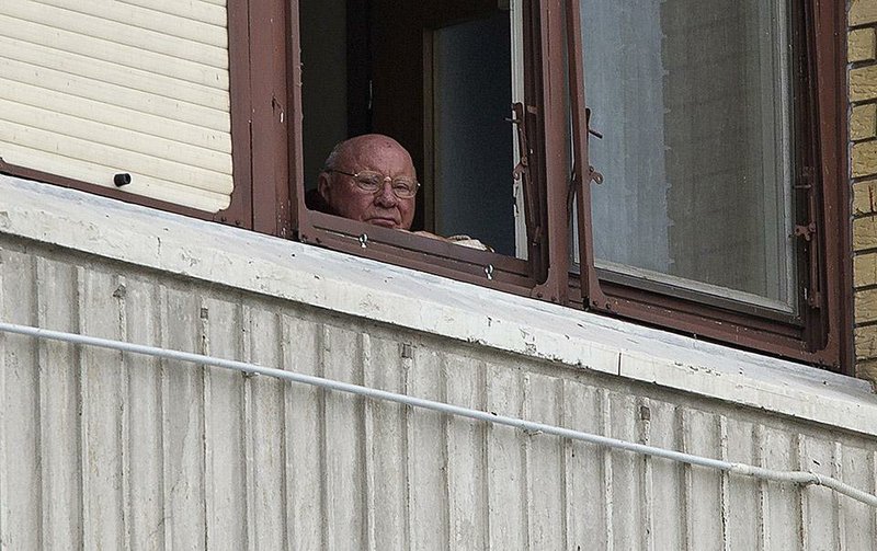 ADVANCE FOR 9:00 P.M., SUNDAY, OCT. 19 AND THEREAFTER - In this July 28, 2014, photo, Jakob Denzinger looks from his apartment window in Osijek, eastern Croatia. Denzinger is among dozens of death camp guards and suspected Nazi war criminals who collected millions of dollars in Social Security payments despite being forced out of the U.S. An Associated Press investigation found dozens of suspected Nazi war criminals and SS guards collected millions of dollars in Social Security payments after being forced out of the United States. (AP Photo/Darko Bandic)